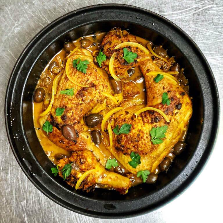 Chicken Tagine with Preserved Lemons in a black bowl