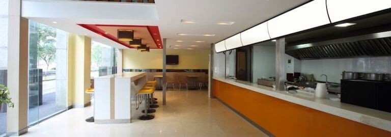Empty fast food restaurant dining room and counter.