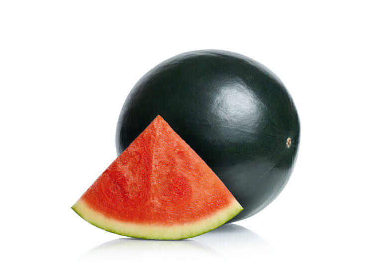 A Densuke watermelon, with the full black watermelon set behind a seedless slice.