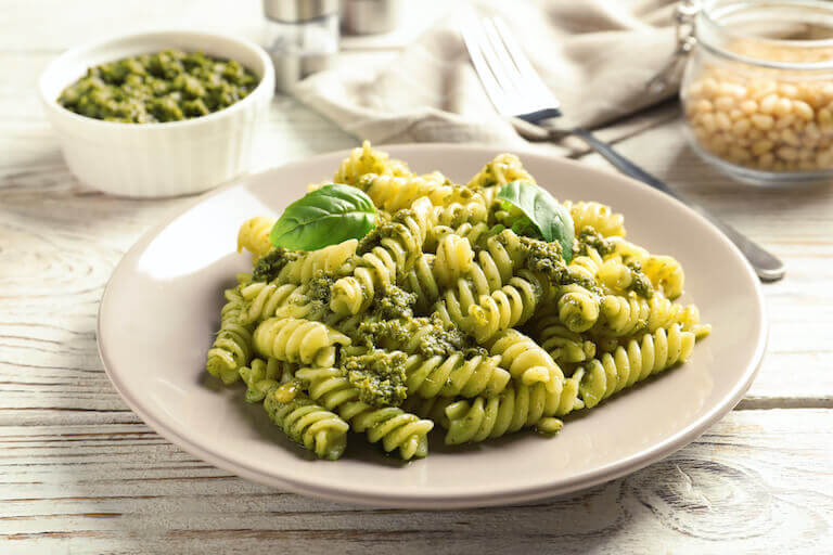 Tan plate with basil pesto pasta