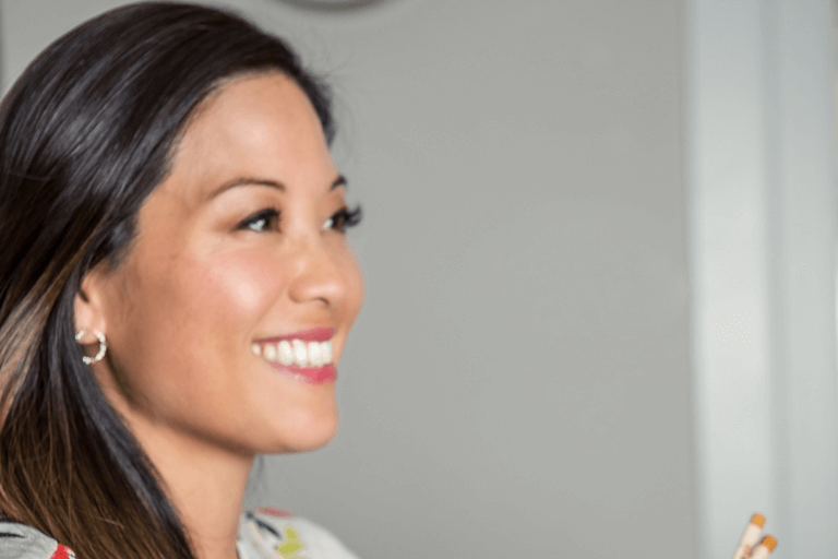 Amy Kimoto-Kahn holding a bowl and a pair of chopsticks.