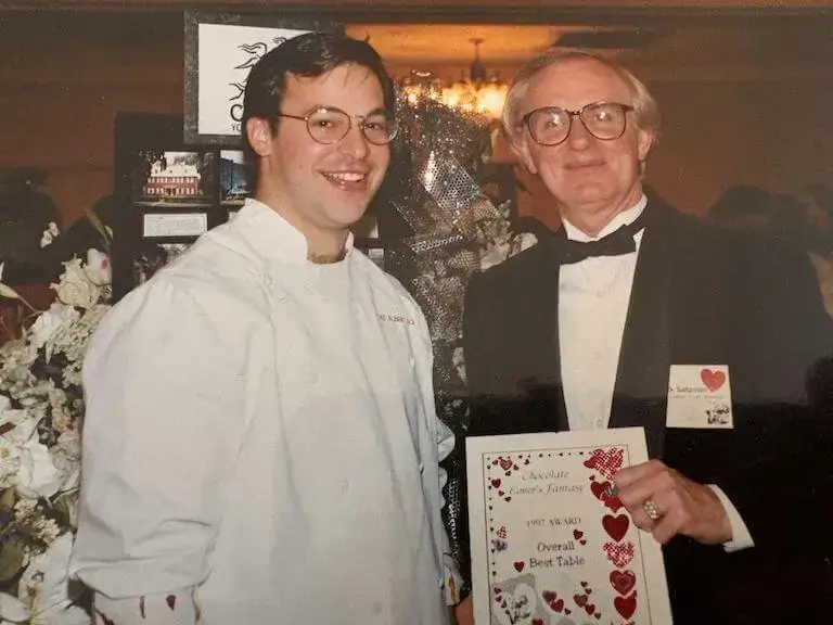 Chef Albert Schmid being presented an award after winning a chocolate competition.