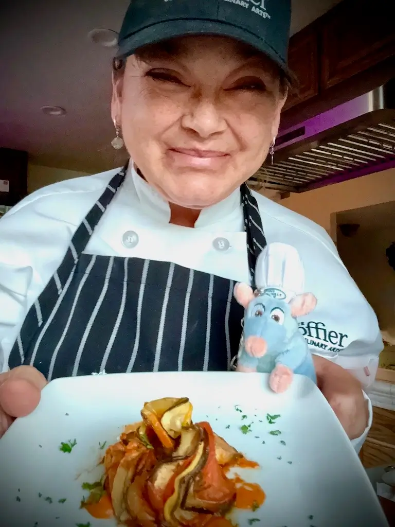 Daniela Peregrina smiles while posing with a plate of Ratatouille she made for an assignment at Escoffier.